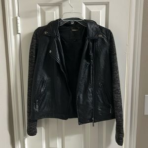 Leather jacket/sleeves are cloth material. Black leather.Sleeves are black&grey